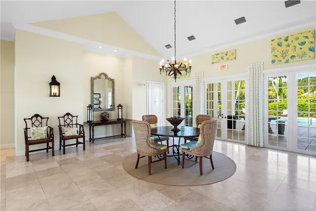 a dining room with furniture a chandelier and wooden floor