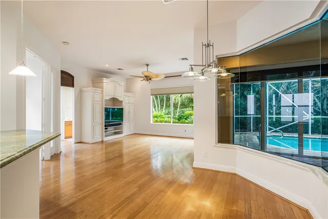 a view of a room with wooden floor and a window