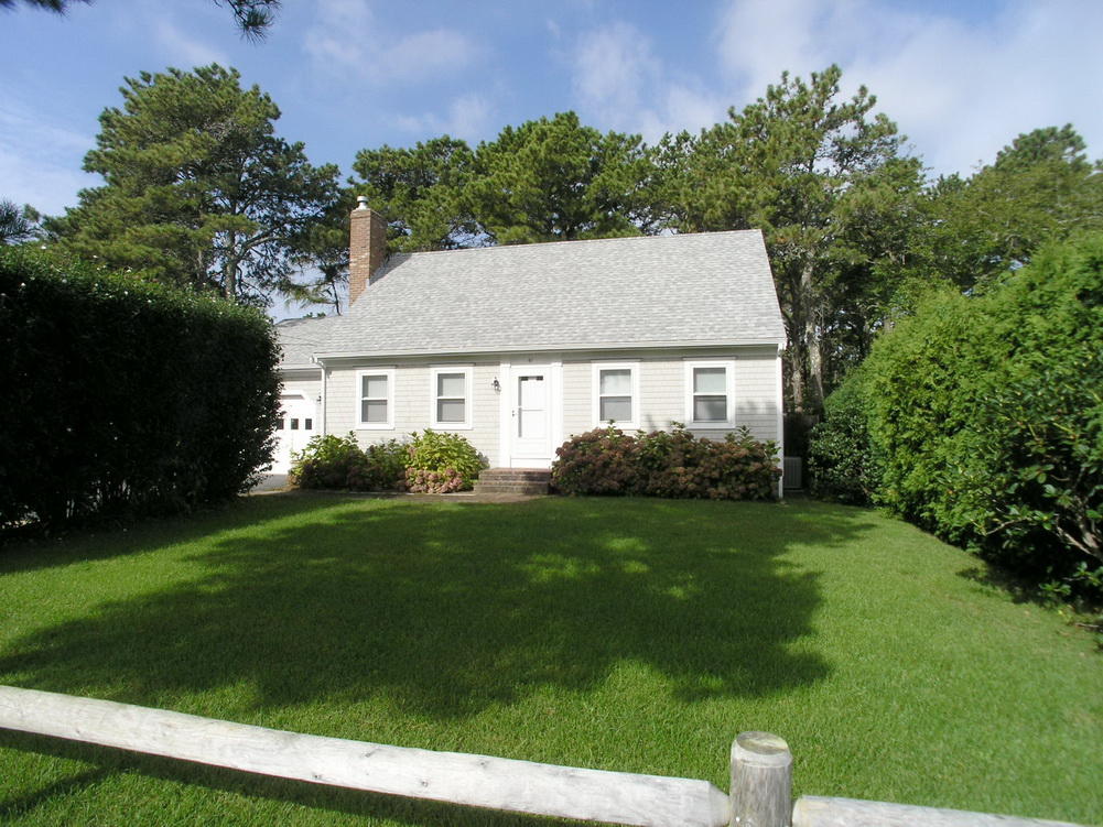 61 Bain Road Dennis Port, MA 02639 - Photo 1 of 22 a view of a house with a backyard