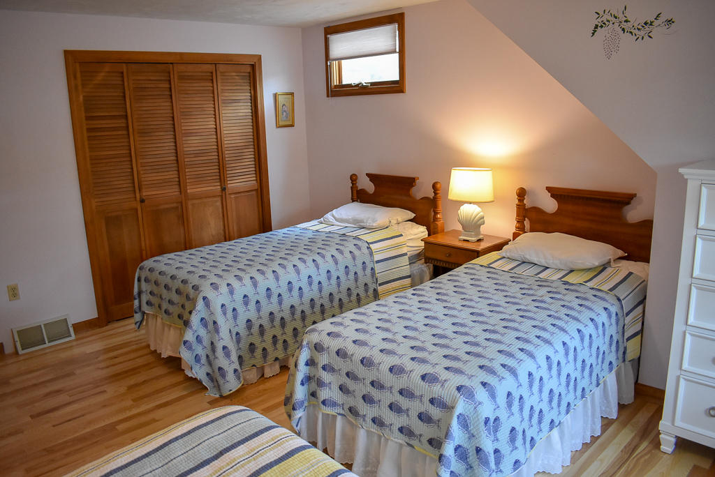 61 Bain Road Dennis Port, MA 02639 - Photo 16 of 22 a bedroom with two beds and wooden floor