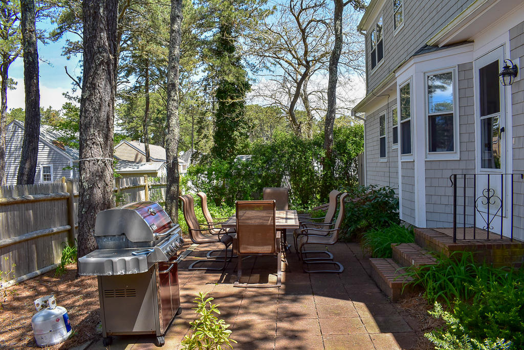 61 Bain Road Dennis Port, MA 02639 - Photo 18 of 22 a building outdoor space with patio furniture