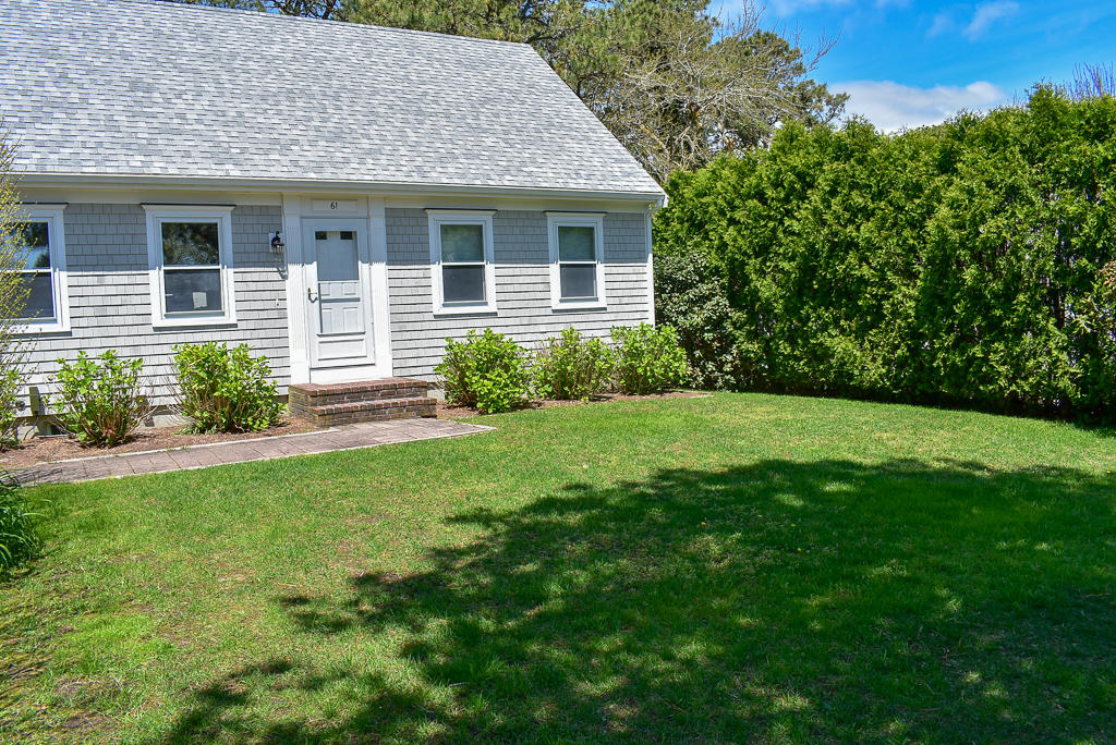 61 Bain Road Dennis Port, MA 02639 - Photo 21 of 22 a front view of a house with a yard