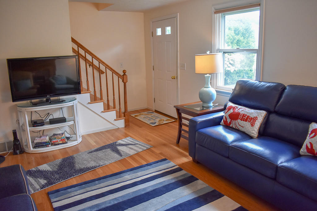 61 Bain Road Dennis Port, MA 02639 - Photo 4 of 22 a living room with furniture and a flat screen tv
