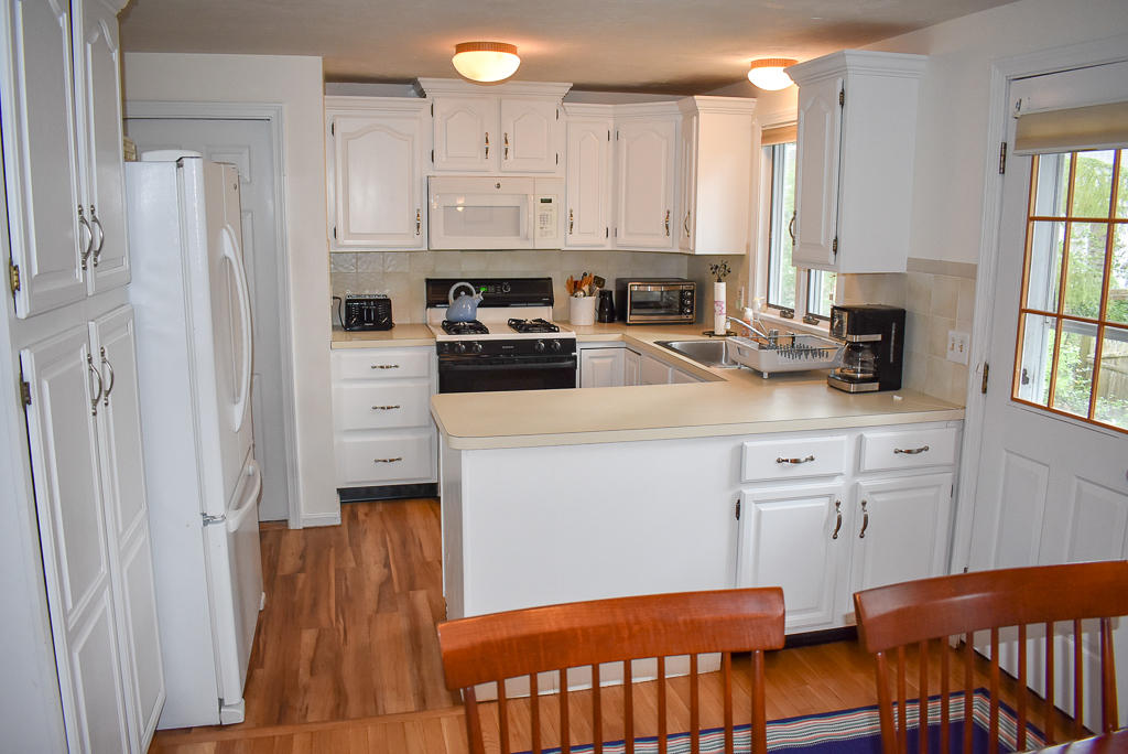 61 Bain Road Dennis Port, MA 02639 - Photo 6 of 22 a kitchen with stainless steel appliances white cabinets and a refrigerator
