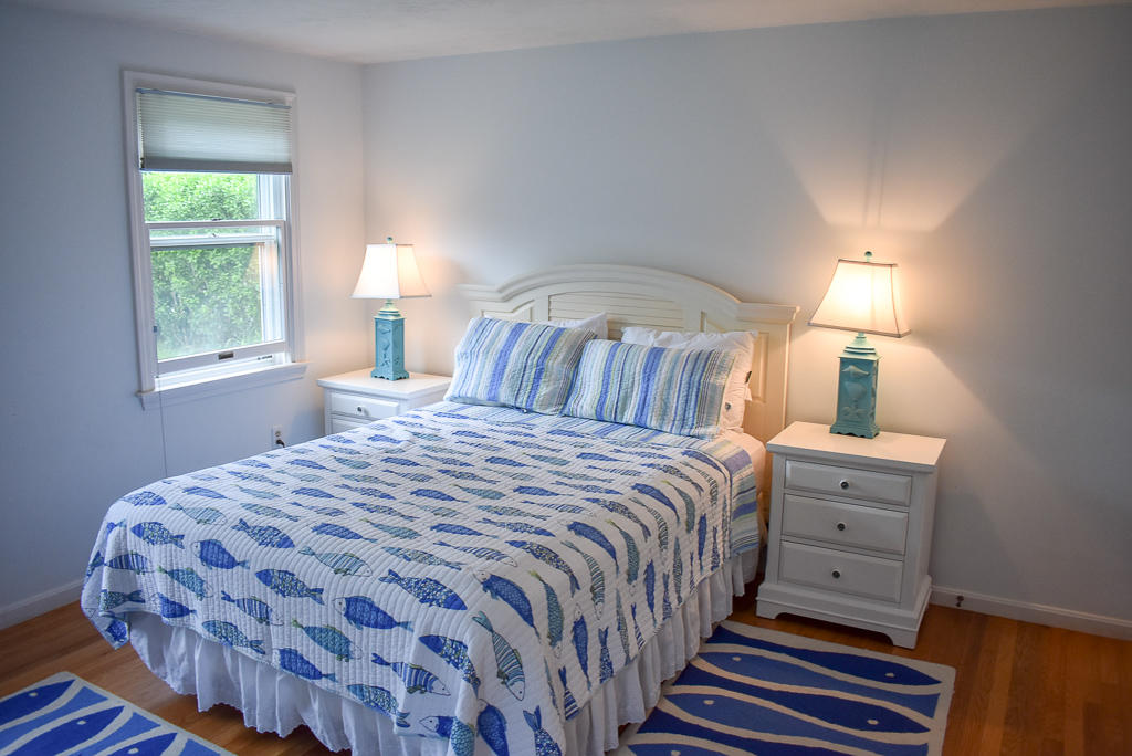 61 Bain Road Dennis Port, MA 02639 - Photo 9 of 22 a bedroom with a bed and a lamp