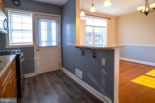 a view of a room with wooden floor and windows