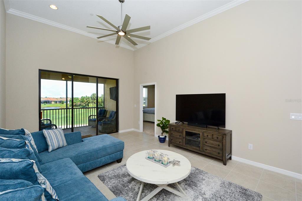13737 Messina Loop, Unit 202 Lakewood Ranch, FL 34211 - Photo 10 of 49 a living room with furniture and a flat screen tv