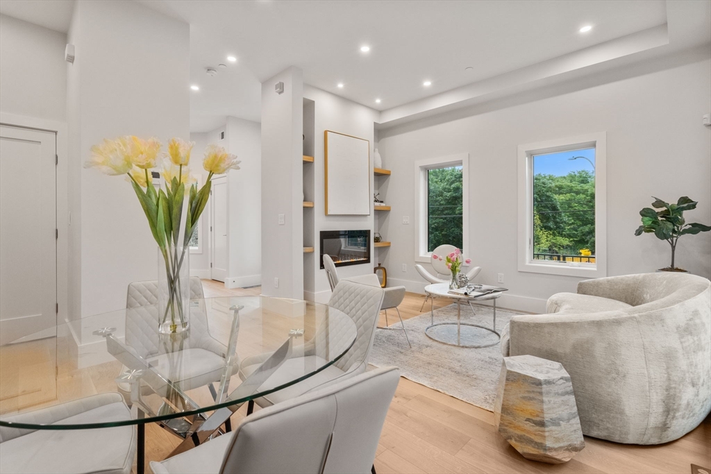 2202 Commonwealth Avenue, Unit 1 Newton, MA 02466 - Photo 11 of 34 a living room with fireplace furniture and a potted plant