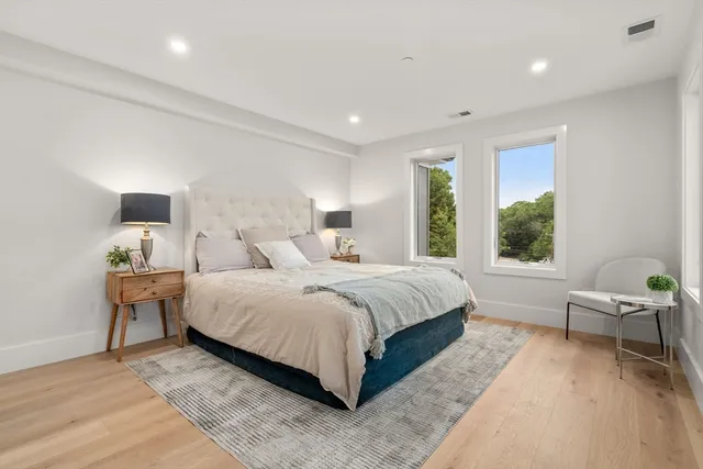 a spacious bedroom with a bed and window