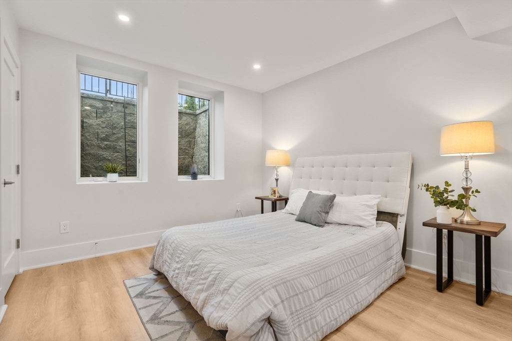 2202 Commonwealth Avenue, Unit 1 Newton, MA 02466 - Photo 27 of 34 a bedroom with a bed and lamps