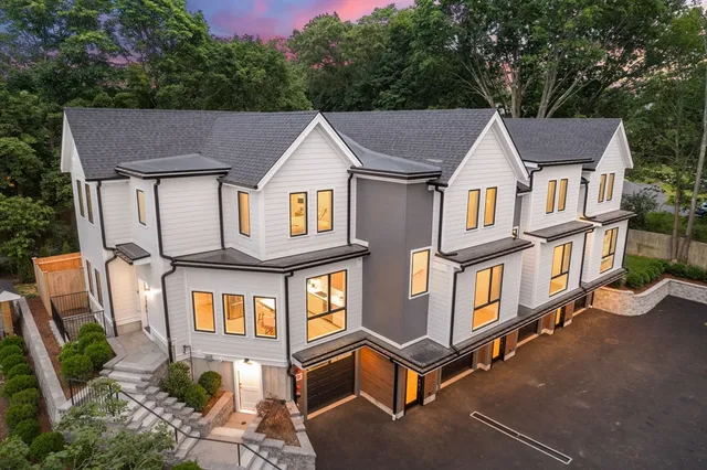 an aerial view of a house with swimming pool and glass windows