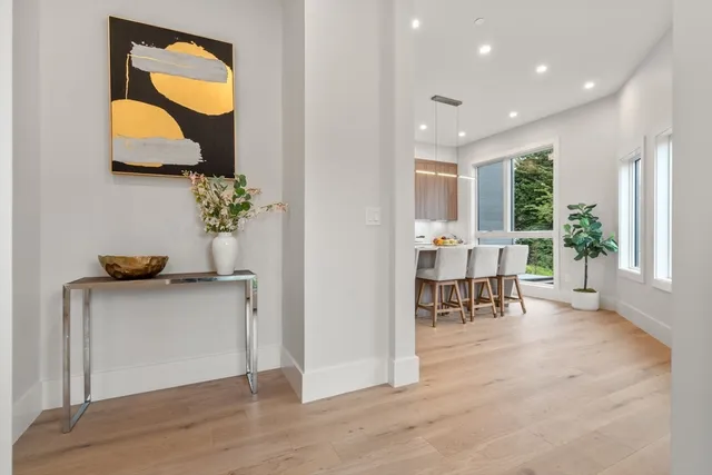 a living room with furniture and a painting on the wall