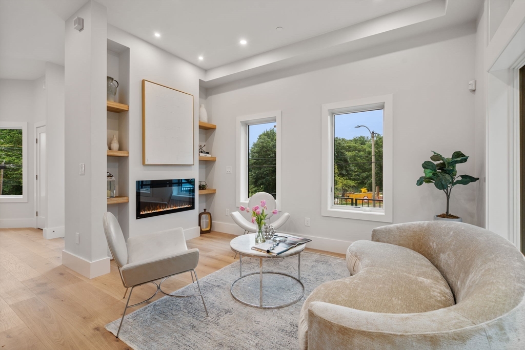 2202 Commonwealth Avenue, Unit 1 Newton, MA 02466 - Photo 7 of 34 a living room with furniture and a fireplace