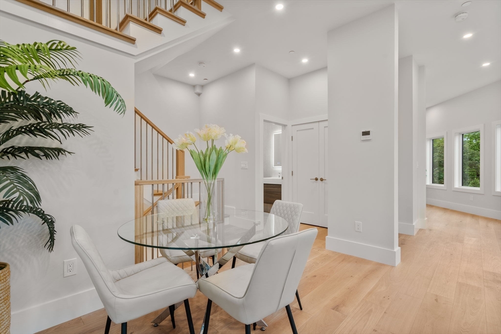 2202 Commonwealth Avenue, Unit 1 Newton, MA 02466 - Photo 9 of 34 a dining room with furniture and wooden floor