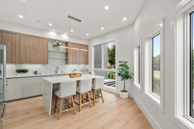 a kitchen with a sink and chairs