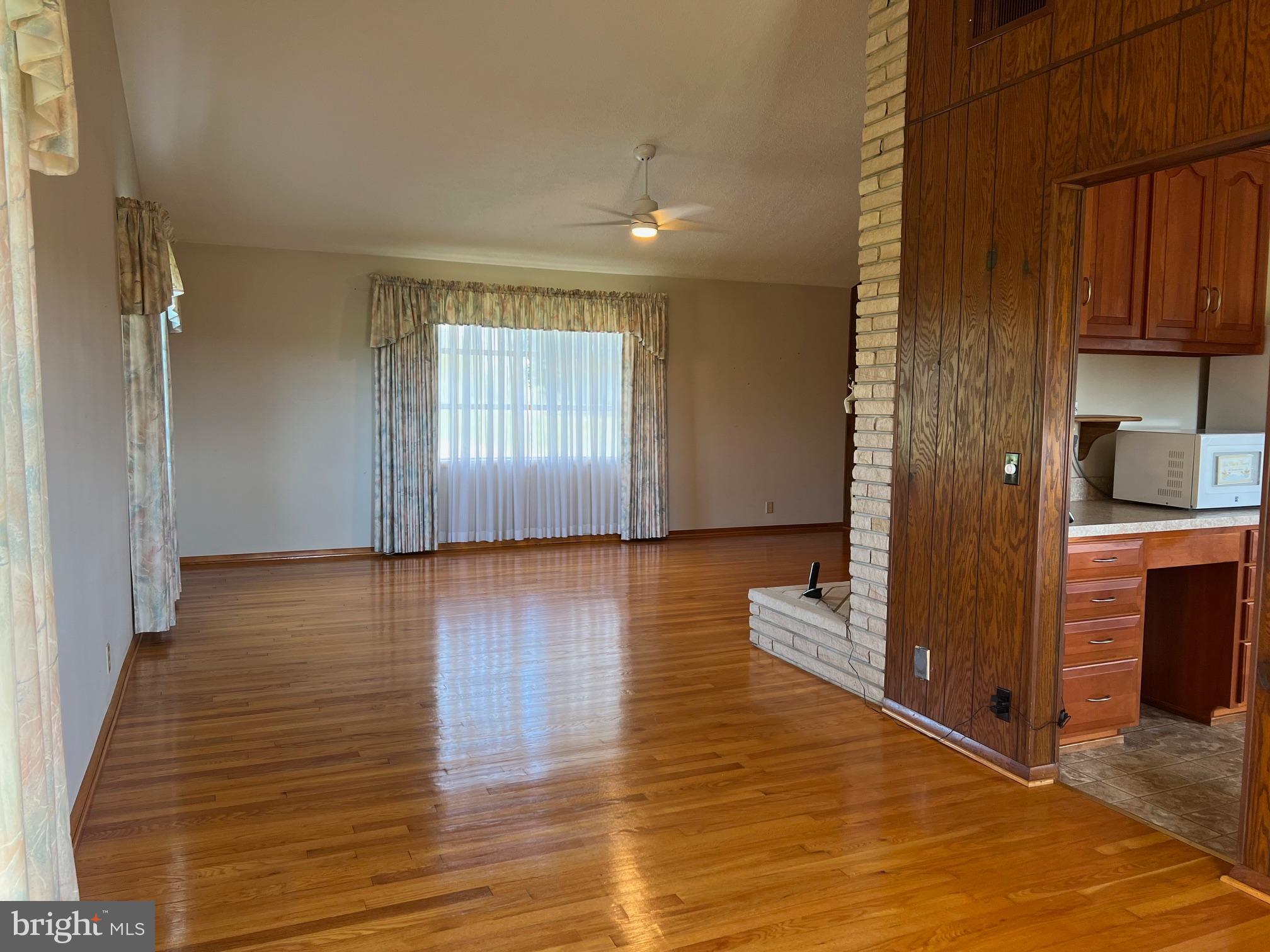 15009 Falling Waters Road Williamsport, MD 21795 - Photo 3 of 16 an empty room with wooden floor and windows