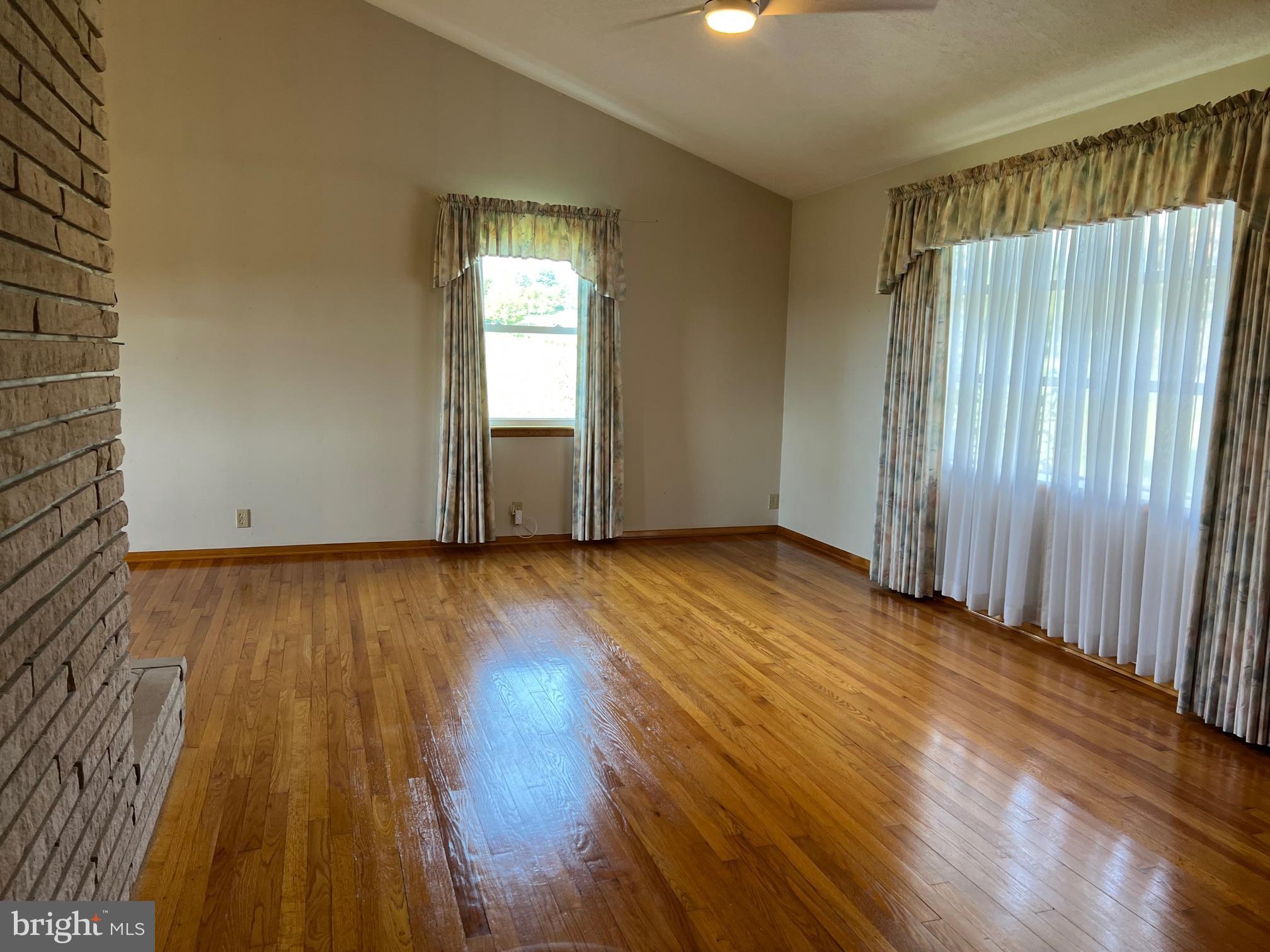 15009 Falling Waters Road Williamsport, MD 21795 - Photo 16 of 16 an empty room with wooden floor and windows