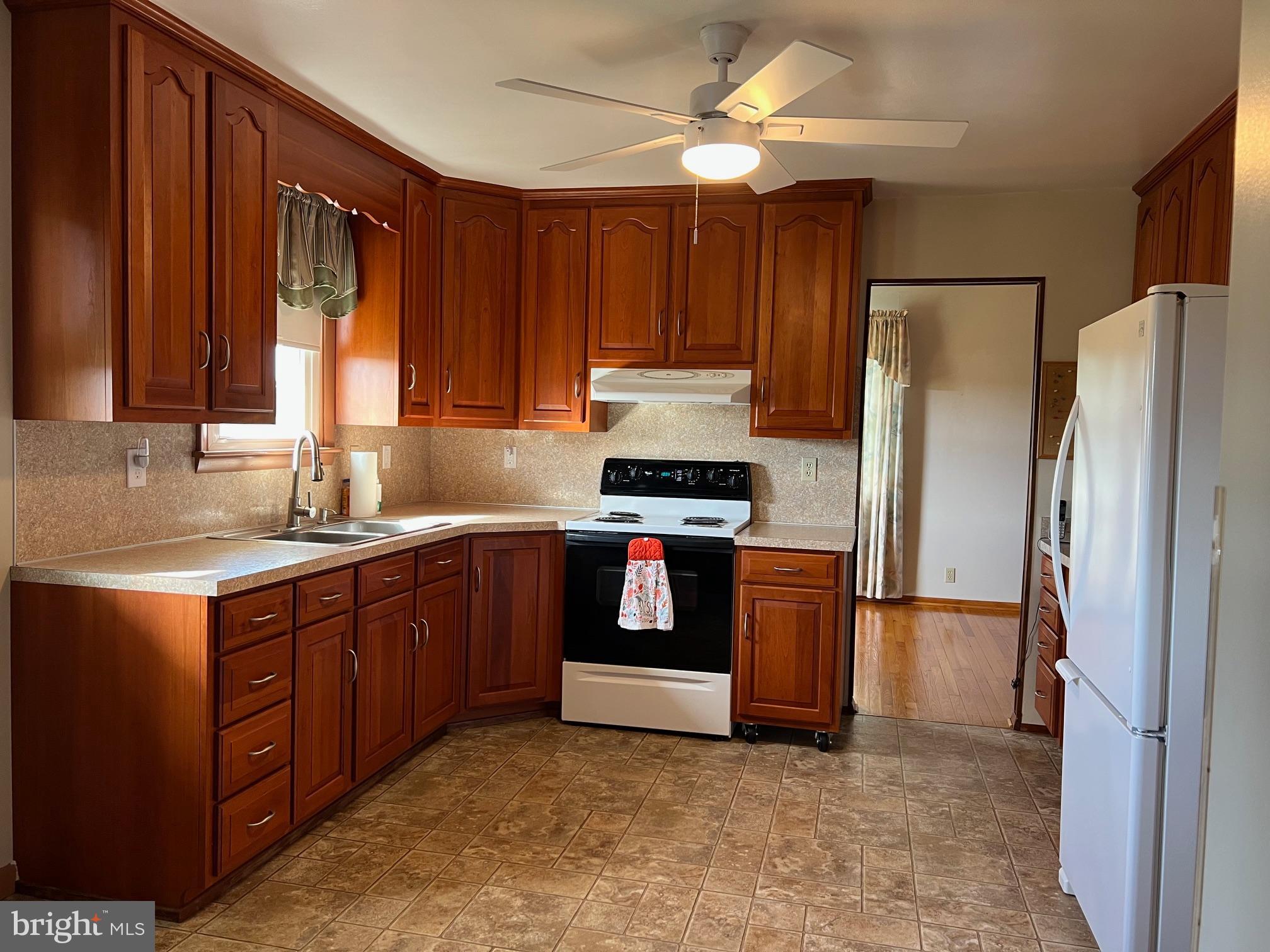 15009 Falling Waters Road Williamsport, MD 21795 - Photo 4 of 16 a kitchen with stainless steel appliances granite countertop a refrigerator stove and sink