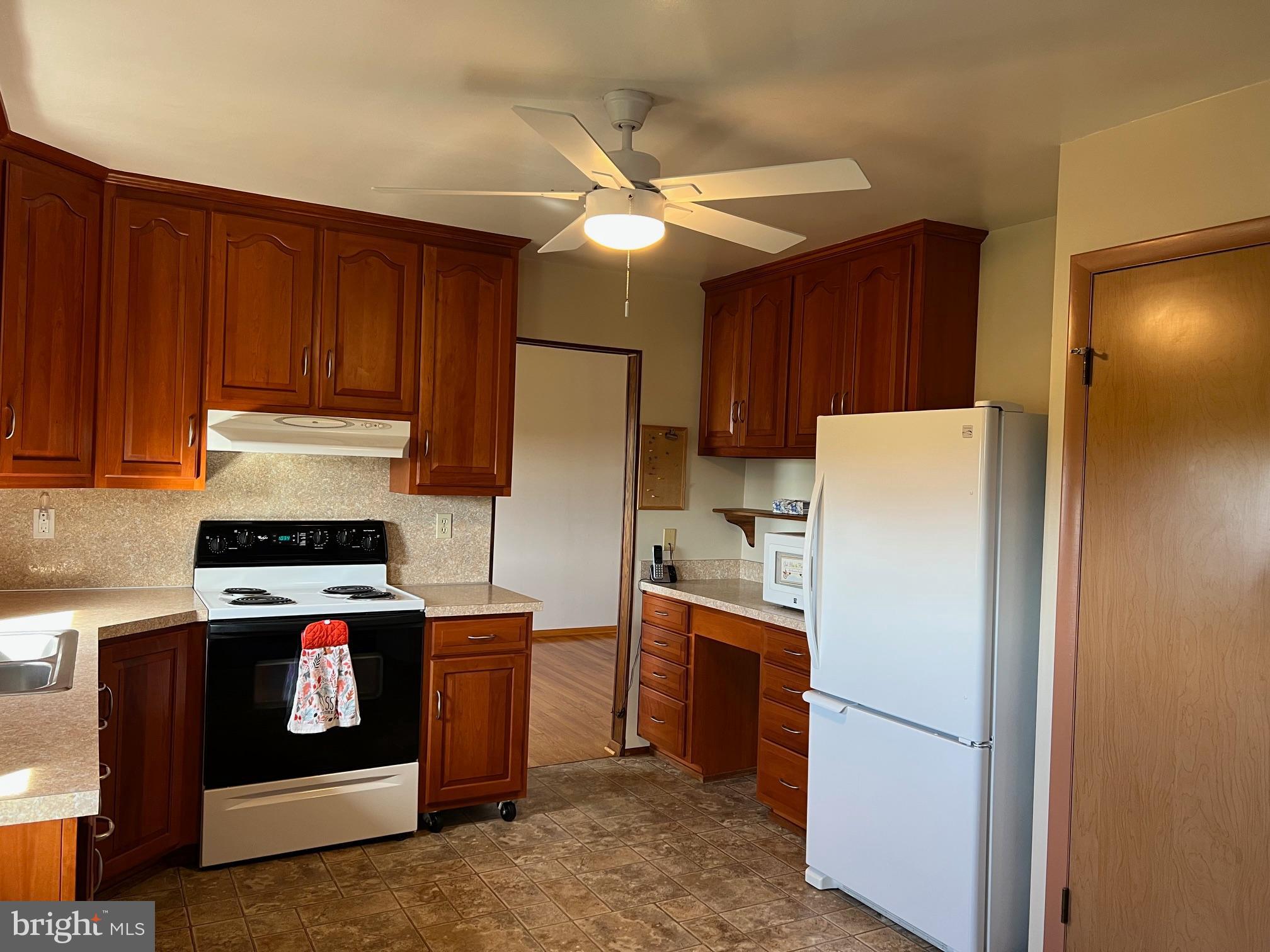 15009 Falling Waters Road Williamsport, MD 21795 - Photo 5 of 16 a kitchen with a refrigerator sink and stove