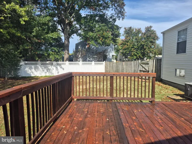 a balcony with wooden floor and fence