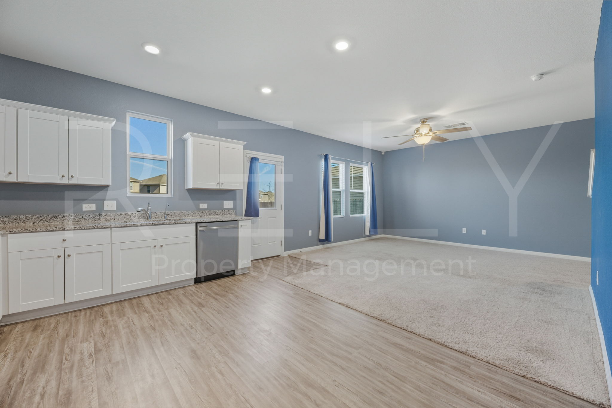 220 Wonderful Life Way Jarrell, TX 76537 - Photo 16 of 35 Kitchen featuring white cabinetry, light stone counters, ceiling fan, dishwasher, and light wood-style flooring