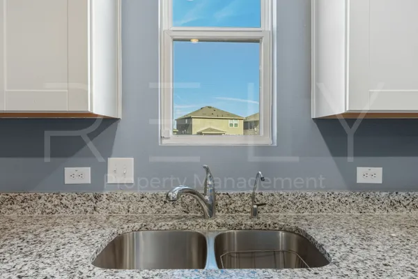a kitchen with a sink and a window