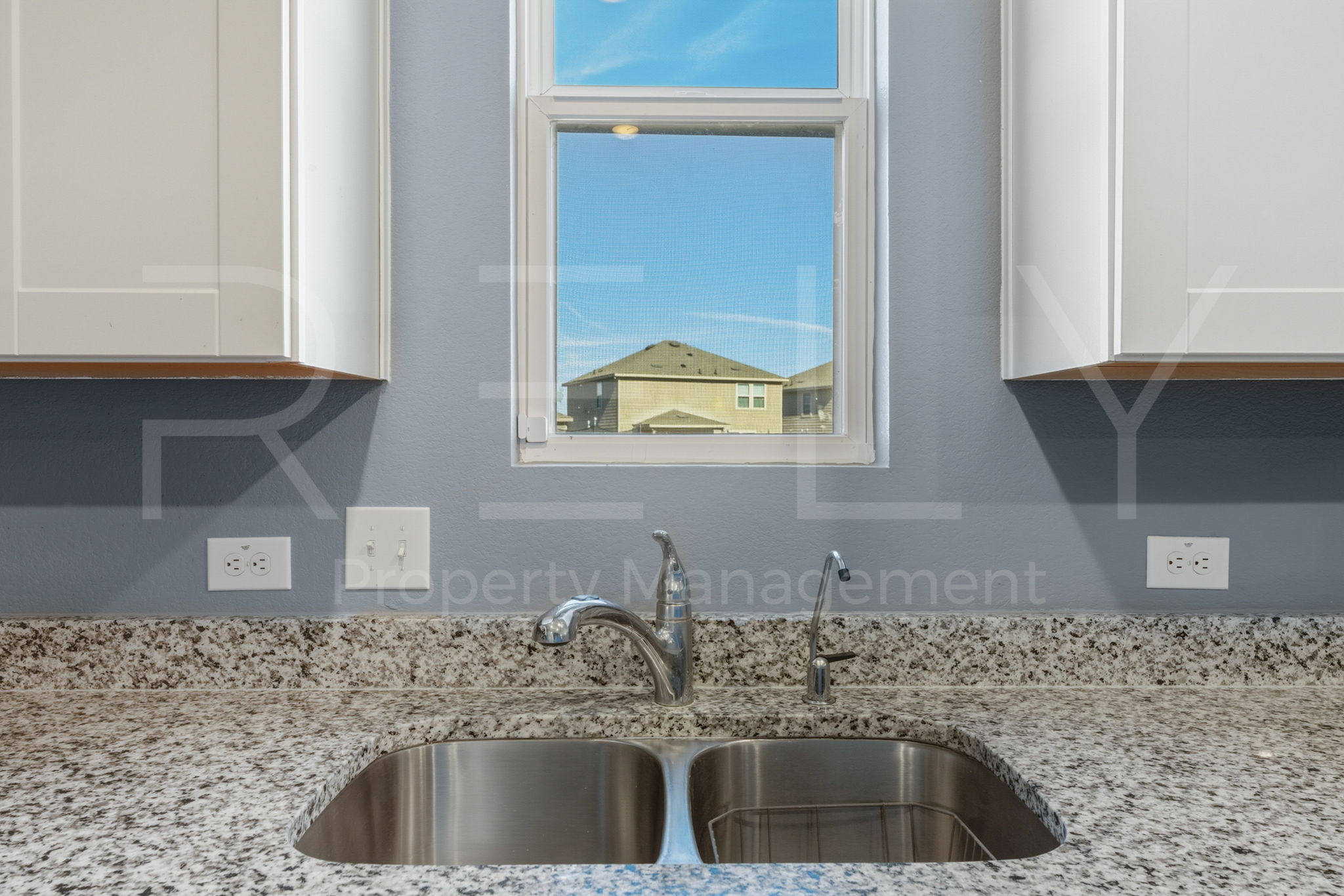 220 Wonderful Life Way Jarrell, TX 76537 - Photo 17 of 35 Kitchen view of light stone countertops and white cabinetry