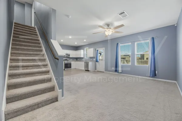 a view of a livingroom with a staircase