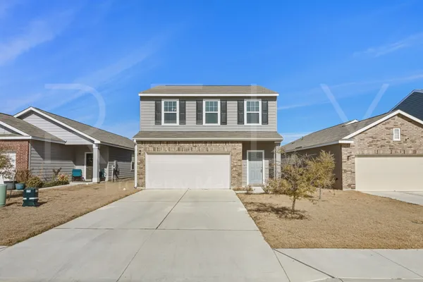 a front view of a house with a yard