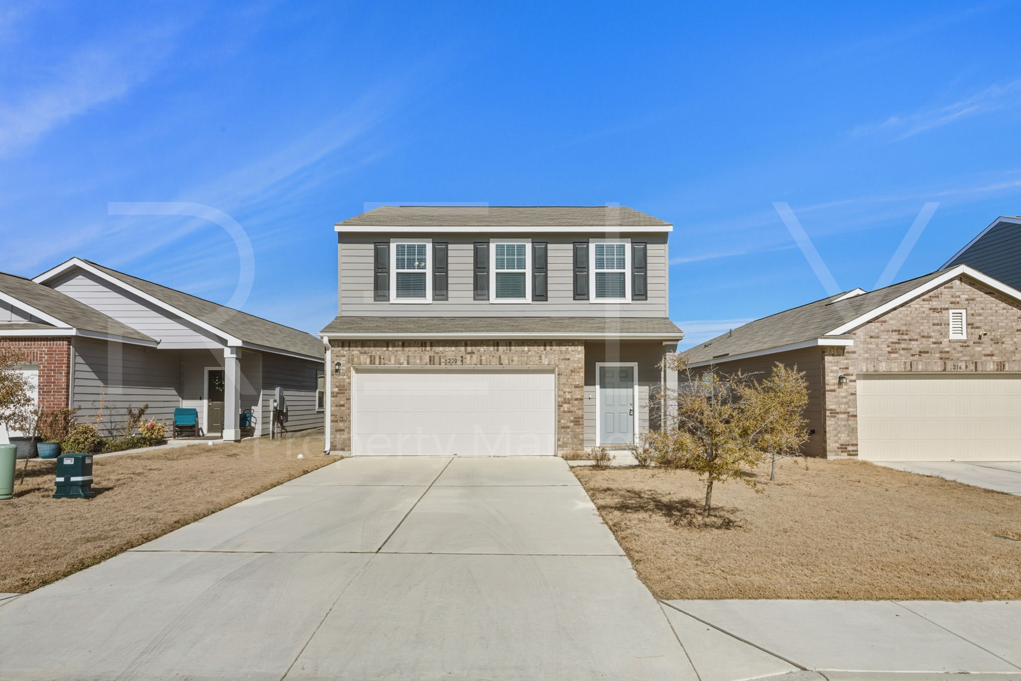 220 Wonderful Life Way Jarrell, TX 76537 - Photo 2 of 35 Traditional-style home with concrete driveway, an attached garage, and brick siding