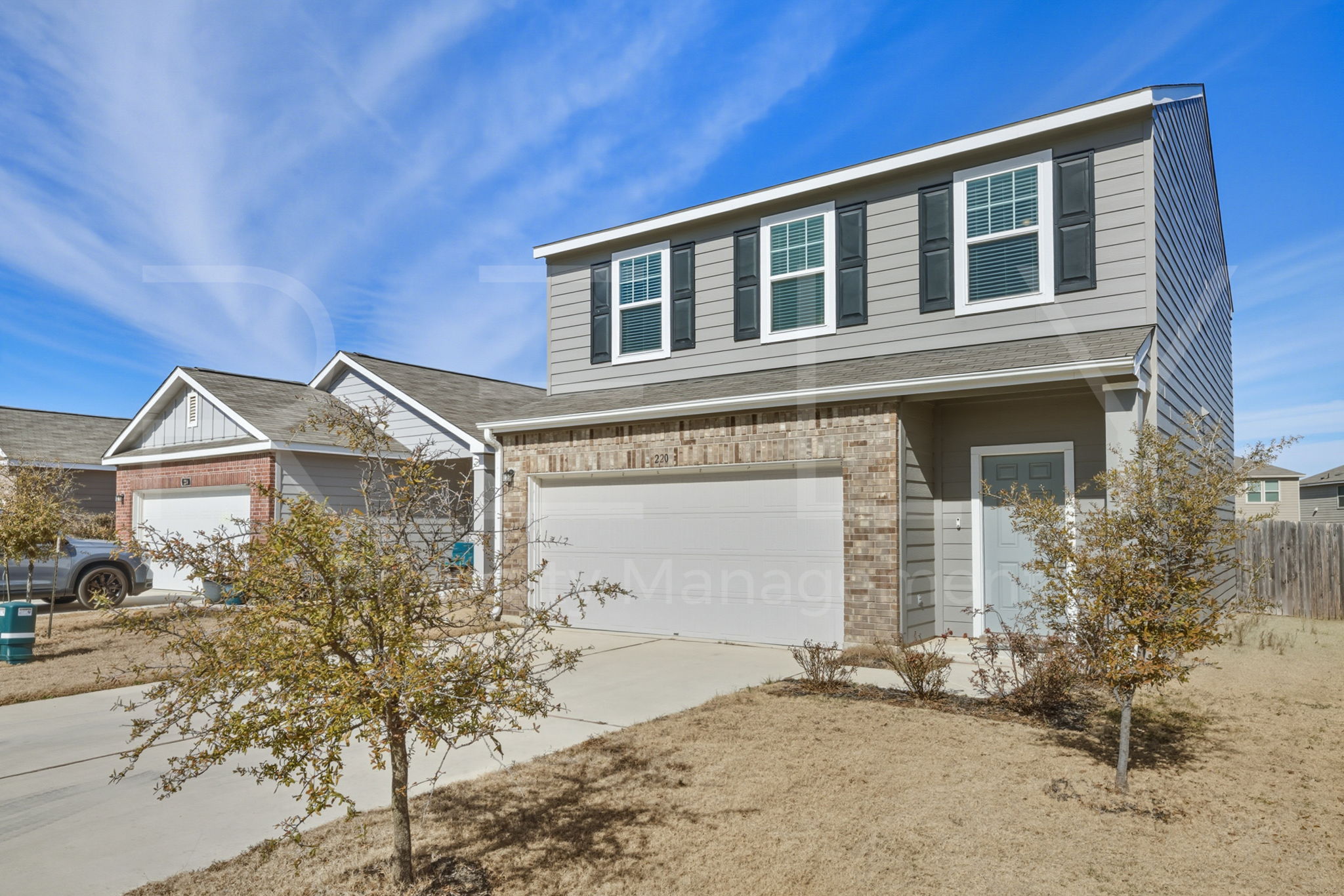 220 Wonderful Life Way Jarrell, TX 76537 - Photo 3 of 35 Traditional home with driveway, a garage, and brick siding