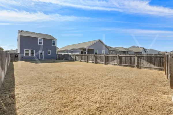 a view of a house with a backyard