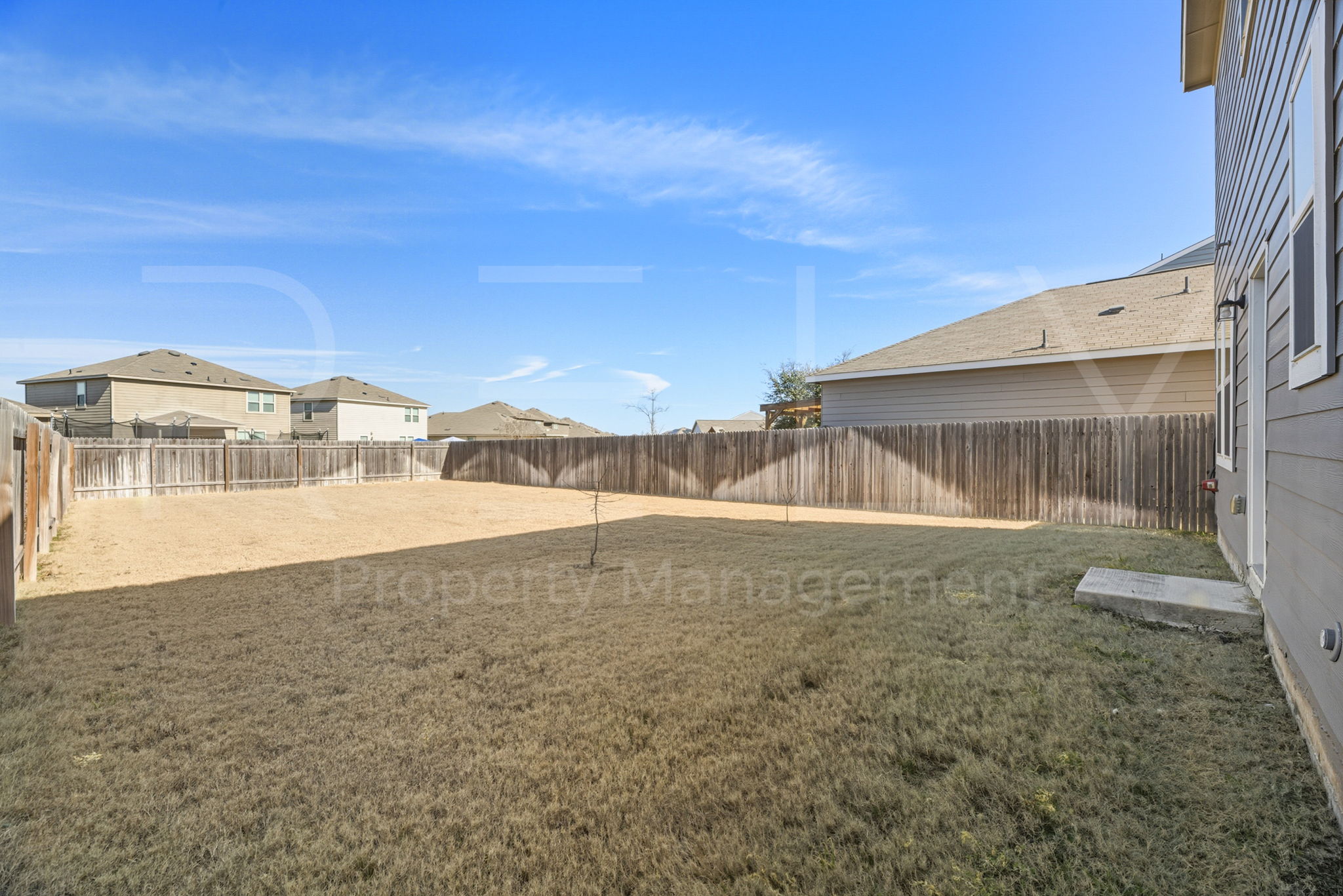 220 Wonderful Life Way Jarrell, TX 76537 - Photo 33 of 35 Fenced backyard with a residential view