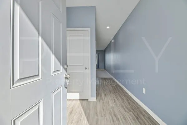 a view of entryway and hall with wooden floor