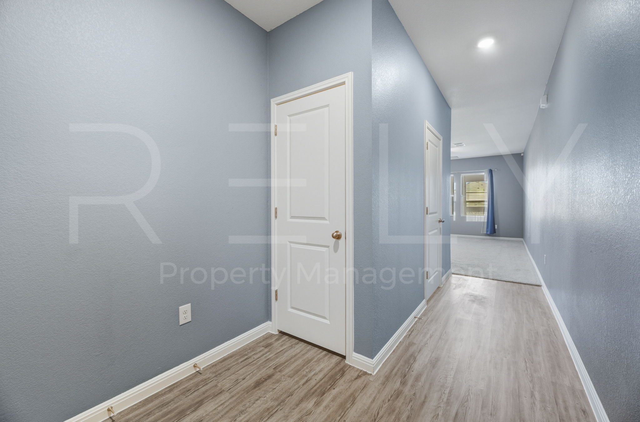 220 Wonderful Life Way Jarrell, TX 76537 - Photo 6 of 35 Hall featuring light wood-style floors and a textured wall