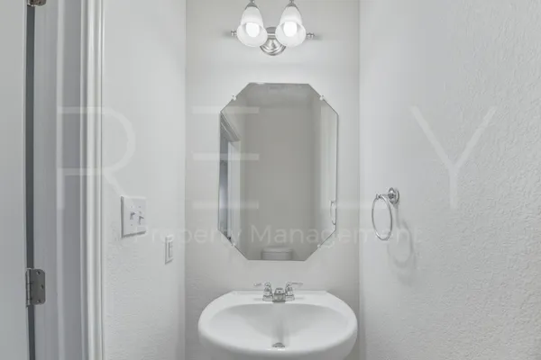 a bathroom with a sink a mirror and a shower