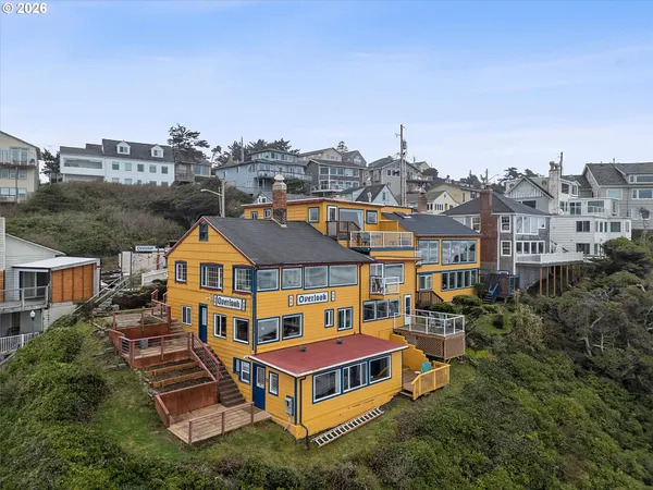 a aerial view of a house with balcony and trees al around