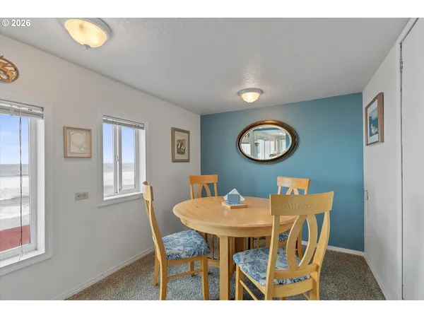 a view of a dining room with furniture and a large window