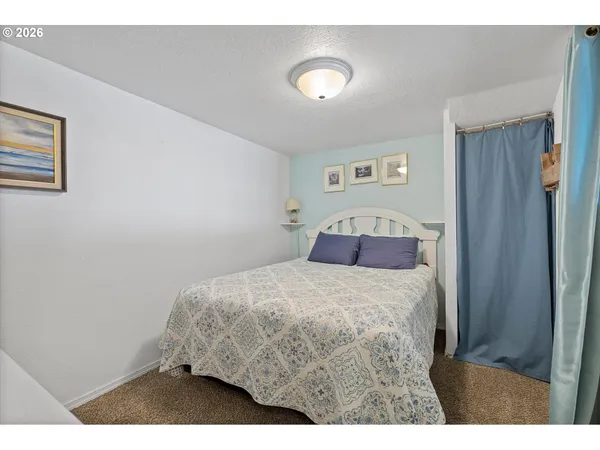 a bedroom with a bed and a night stand