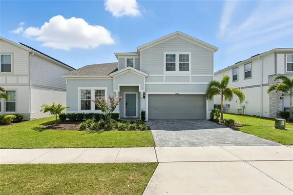 a front view of a house with a yard and garage