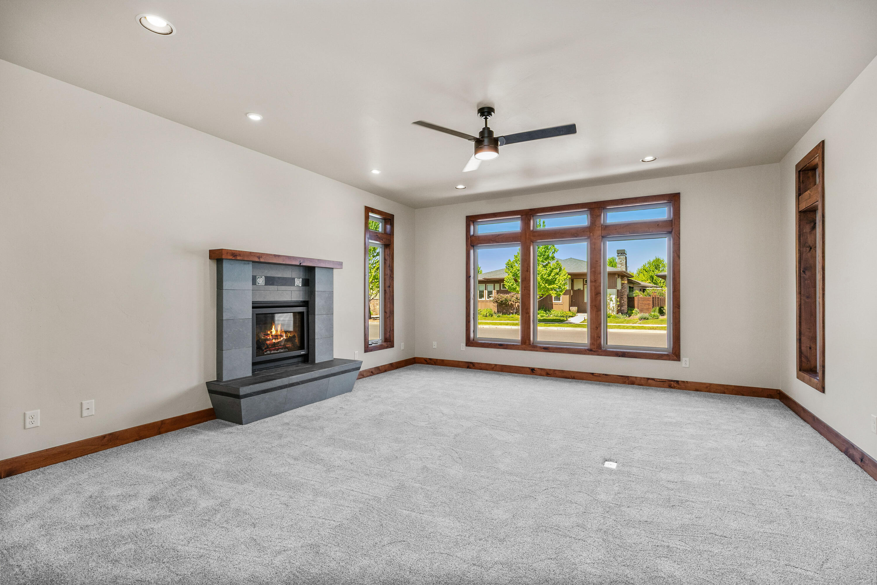 1472 Northeast Hudspeth Road Prineville, OR 97754 - Photo 5 of 26 an empty room with windows and fireplace