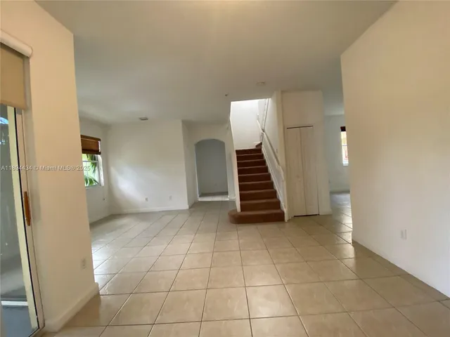 a view of an empty room with stairs and ventilation