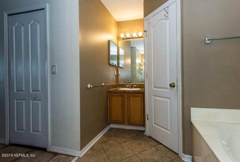 10228 Rising Mist Lane Jacksonville, FL 32221 - Photo 18 of 31 His Sink & Enclosed Water Closet