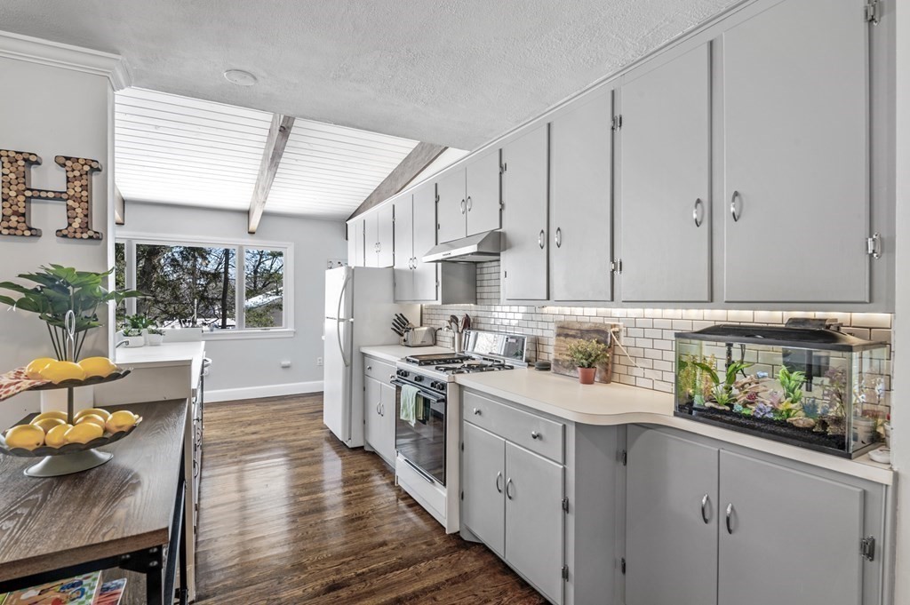 19 Walnut Road Swampscott, MA 01907 - Photo 9 of 36 a kitchen with stainless steel appliances granite countertop a stove a sink dishwasher and cabinets with wooden floor
