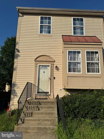 a front view of a house with stairs