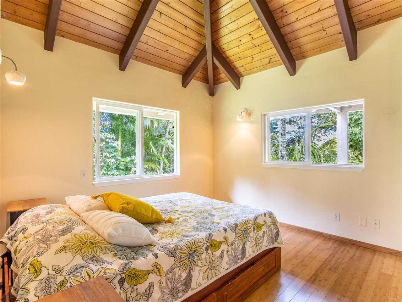 4508 Waha Place Haiku, HI 96708 - Photo 13 of 30 a bedroom with a bed and wooden floor
