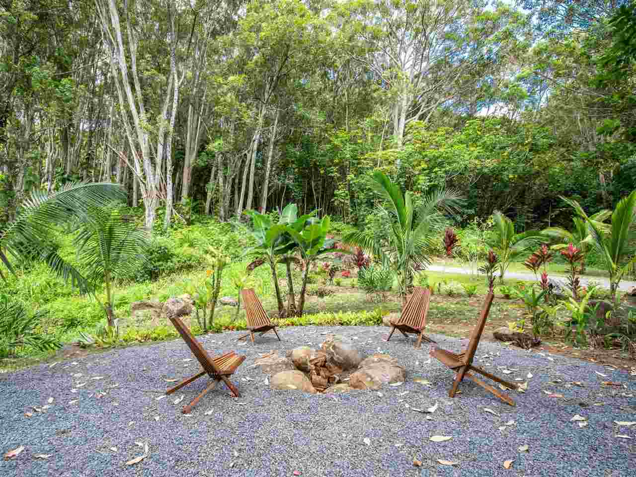 4508 Waha Place Haiku, HI 96708 - Photo 20 of 30 a backyard of a house with table and chairs
