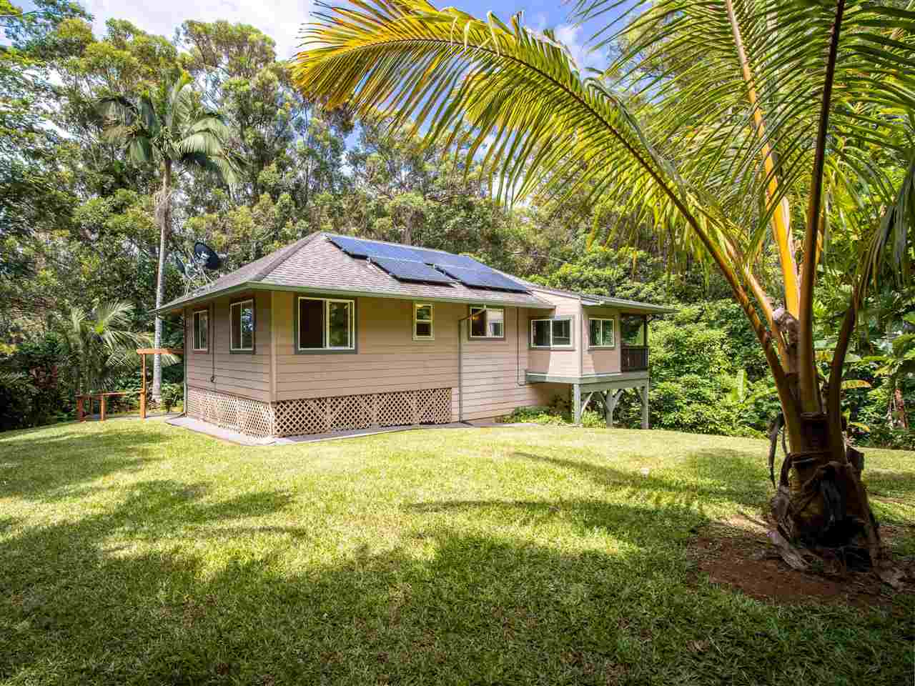 4508 Waha Place Haiku, HI 96708 - Photo 27 of 30 a house with swimming pool in front of it