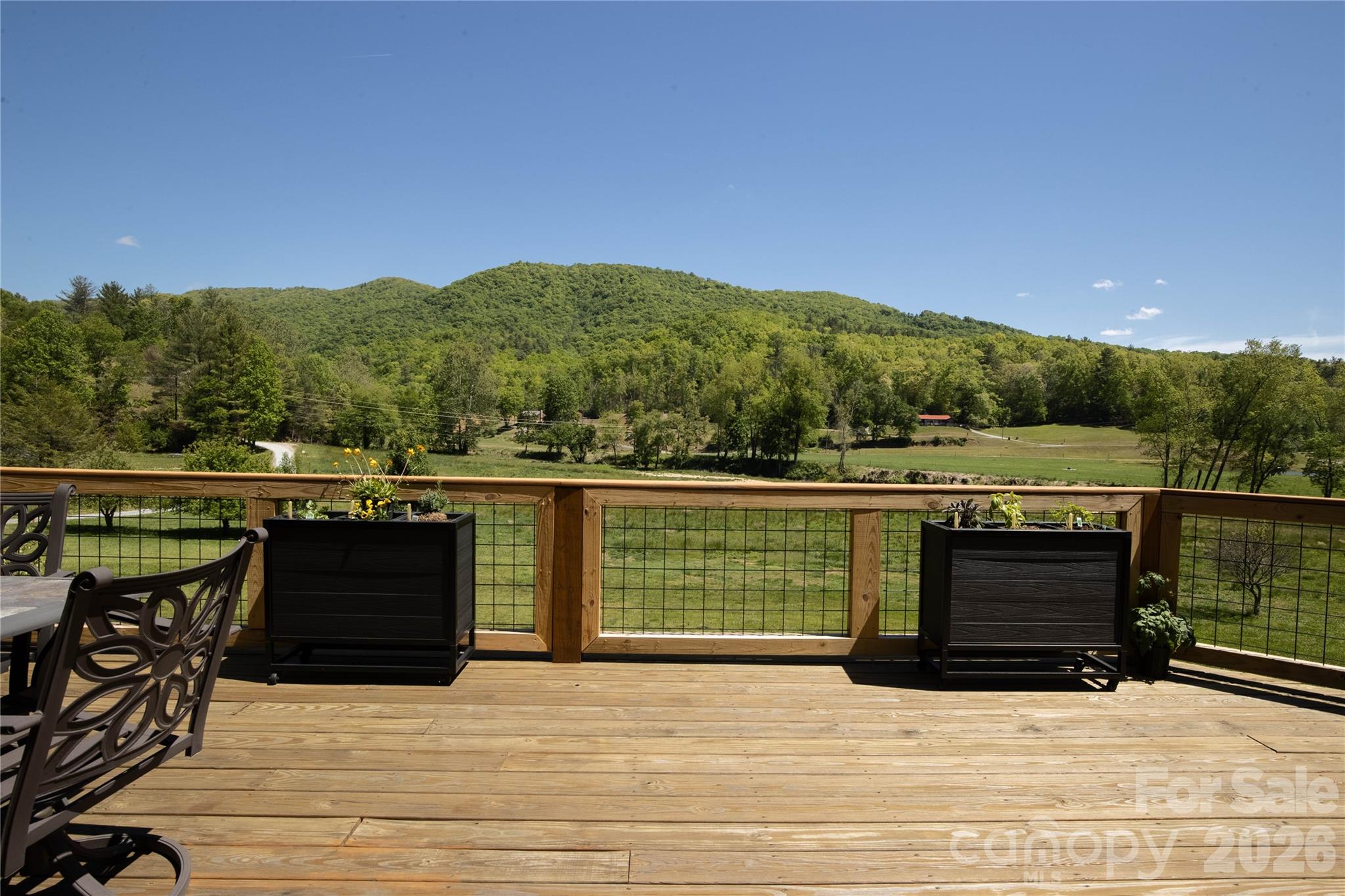 93 Franklin Crest Road Spruce Pine, NC 28777 - Photo 25 of 47 a view of a balcony with wooden floor and lake view