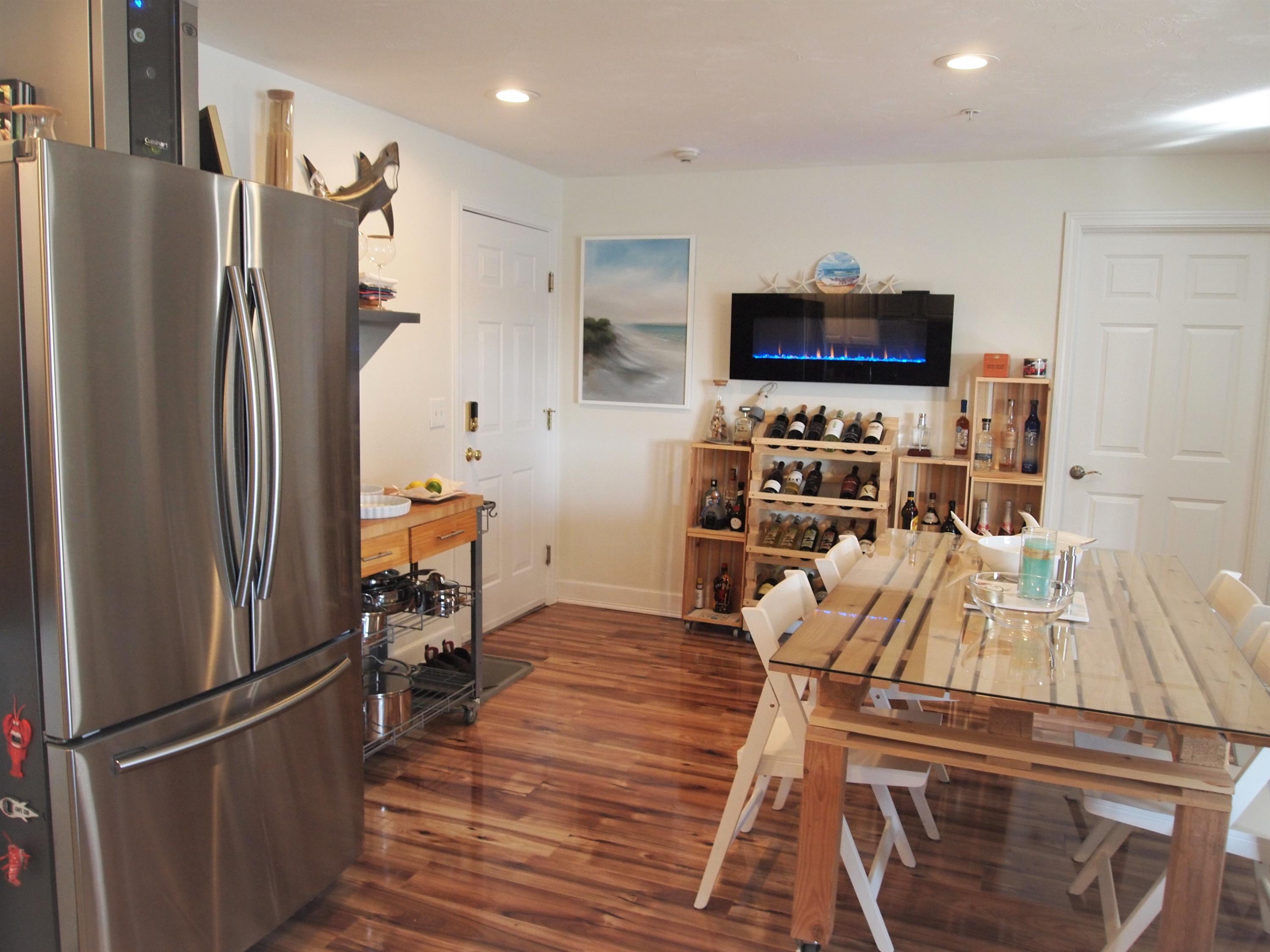 49 E Main Street Buzzards Bay, MA 02532 - Photo 6 of 15 a view of a kitchen with fridge and wooden floor
